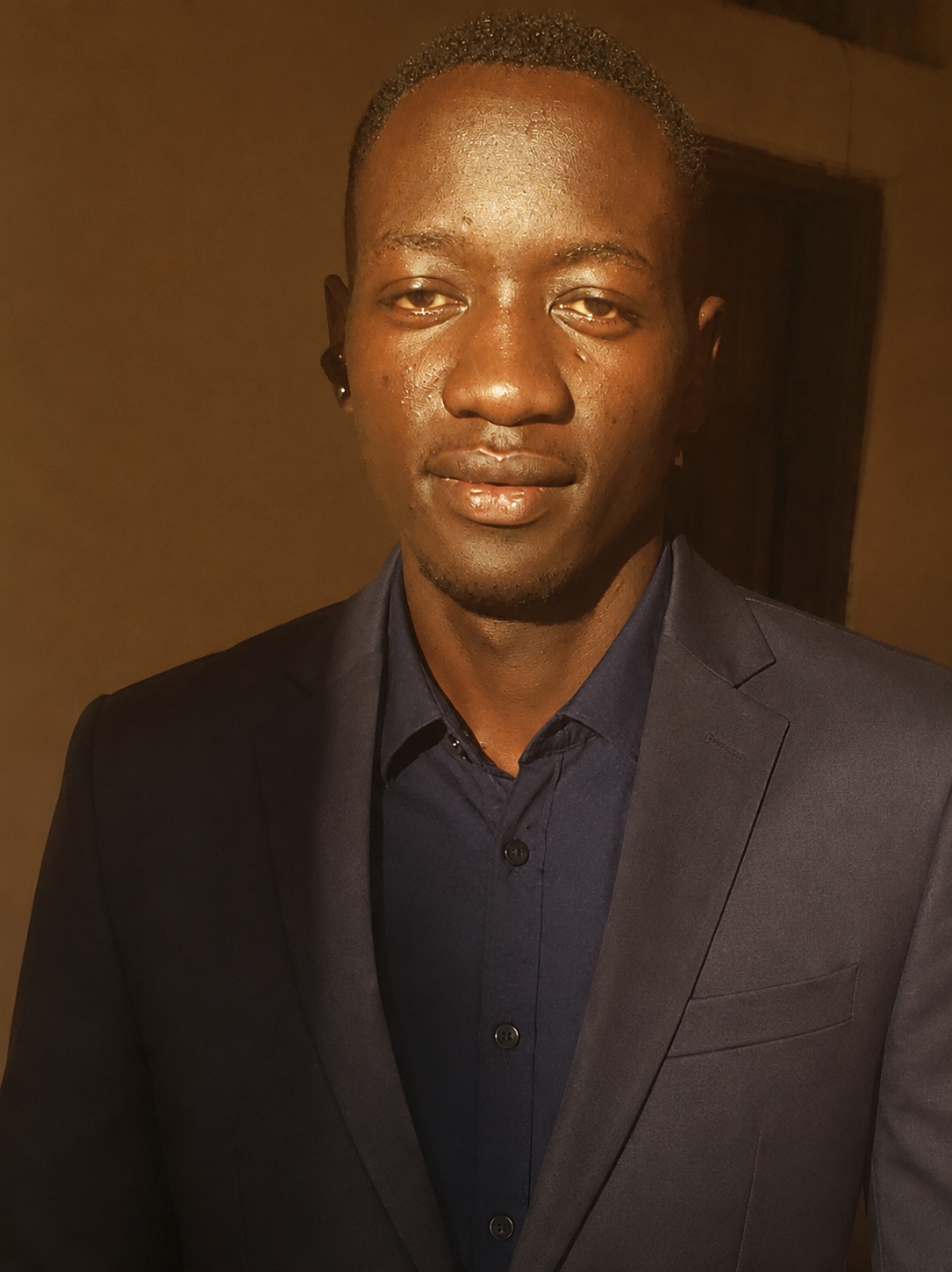 JOHANES MWESIGWA JACKSON in a professional suit